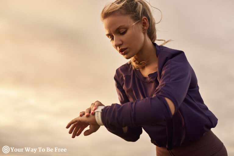 Sportswoman checking pulse on wristwatch, doing fitness