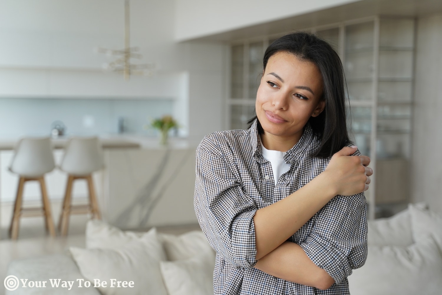 A woman hugging herself showing how to healing ourselves with self-compassion