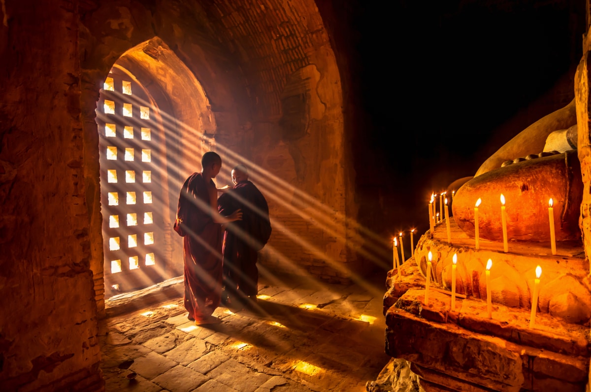 2 man in a temple contemplating their belief
